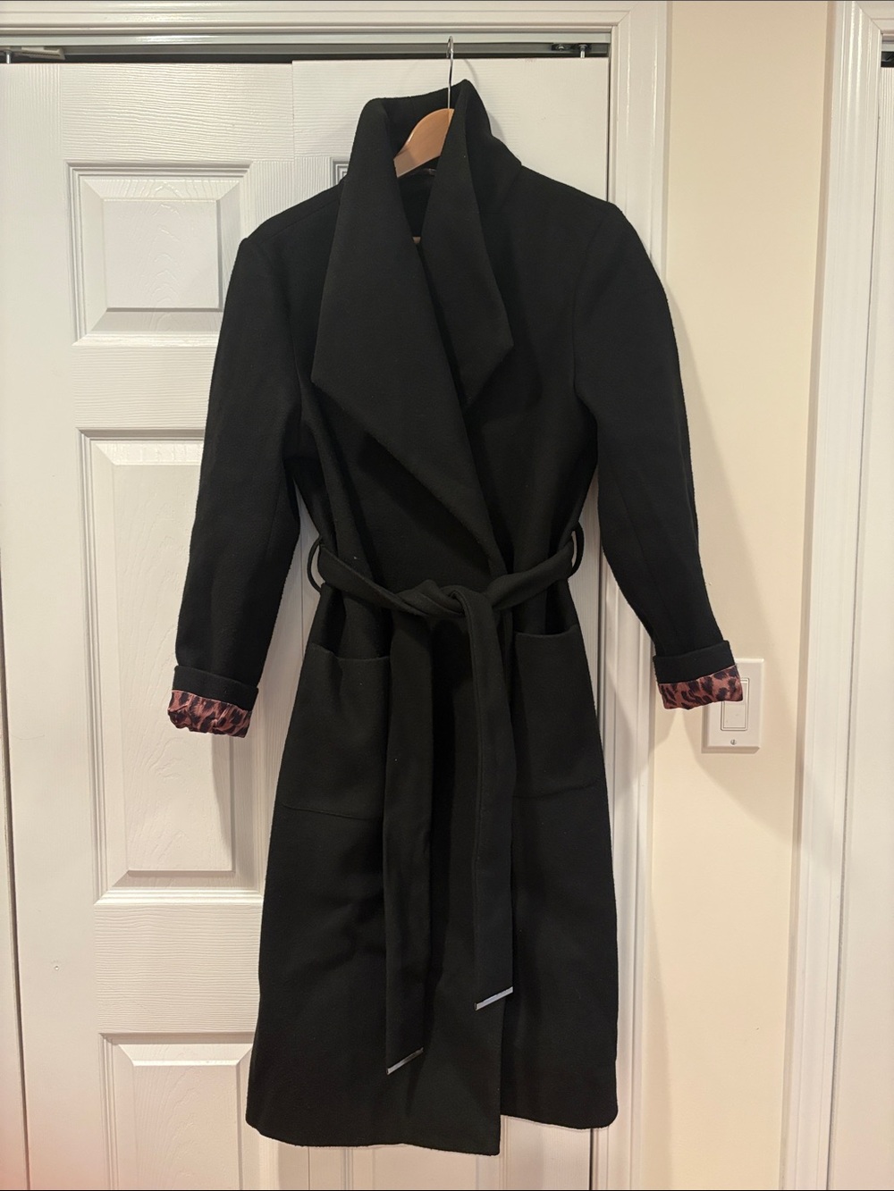 Ricki’s Black Long Belted Wrap Coat with Printed Cuff Detail